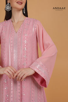 Exquisitely embroidered with traditional design, this pink georgette palazzo suit will surely make a standout addition at every party you go.

This v-neck and full sleeve suit highlighted with resham thread, faux mirror, and lace work.

Along with georgette palazzo pant in =pink color with pink georgette dupatta.

Palazzo pant has lace work.

Dupatta embroidered with resham thread and faux mirror work.

This palazzo suit can be customized up to the maximum size available in inches 68.

Slight color variation may occur due to photographic reasons. Faux Mirror, Georgette Palazzo, Georgette Dupatta, Palazzo Suit, Palazzo Pant, Eid Dresses, Dresses 2023, Georgette Fabric