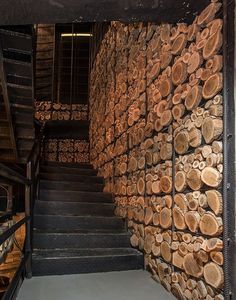 stairs made out of logs in front of a wall