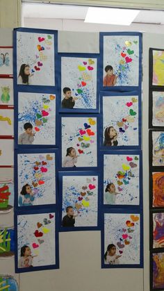 a bulletin board with pictures of children's faces and hearts attached to the wall