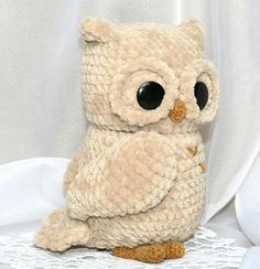 an owl stuffed animal sitting on top of a table