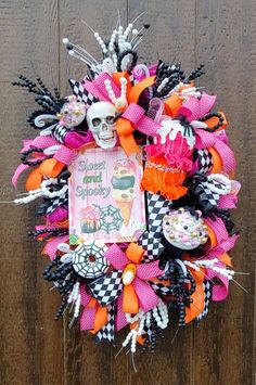 a halloween wreath with a sign and decorations