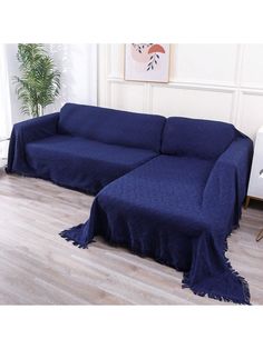 a blue couch sitting on top of a hard wood floor