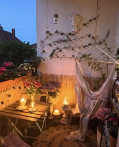 an outdoor patio with candles and potted plants