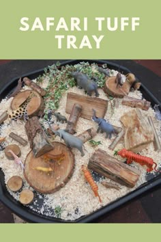 a tray filled with different types of wood and other things on top of it that says safari tuff tray