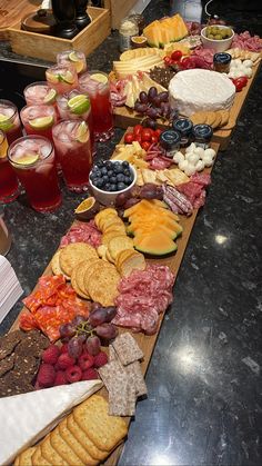 a long table filled with lots of different types of food and drinks on top of it