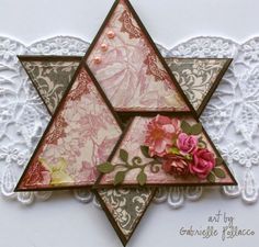 a card with an image of a star of david and pink flowers on the front