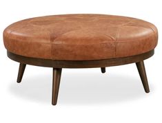 a brown leather ottoman sitting on top of a wooden frame with an oval foot rest