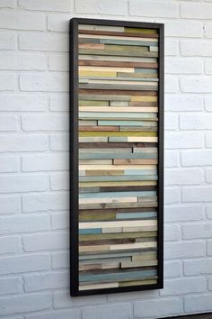 a white brick wall with a black frame and wooden planks on the bottom half