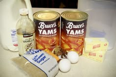 the ingredients to make an apple cider cake are displayed on a counter top, including yogurt, eggs, butter, and sugar