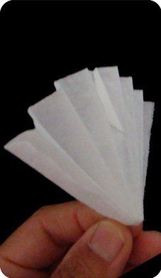 a hand is holding several pieces of white paper