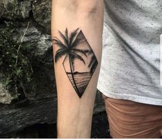 a man with a tattoo on his arm that has a palm tree in the shape of a diamond