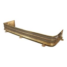 an ornately decorated gold metal shelf on white background