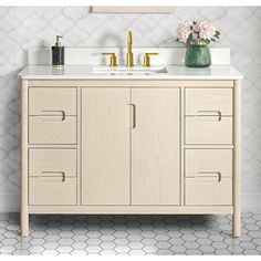 a bathroom vanity with two sinks and gold faucets