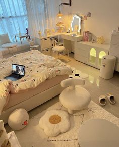 the bedroom is decorated in white and has lots of furniture