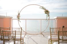 an outdoor ceremony set up on the balcony overlooking the ocean