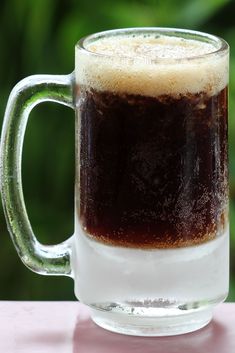 a close up of a cup of beer on a table