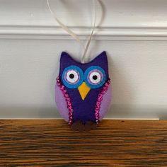 an owl ornament is hanging on the wall