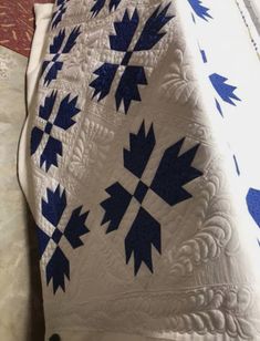 an image of a blue and white quilt on a bed with the words dana's post written below it