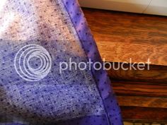 a close up of a purple tie on a wooden table