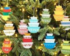 a christmas tree with many different colored bowls hanging from it's branches