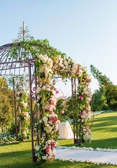 a gazebo decorated with flowers and greenery