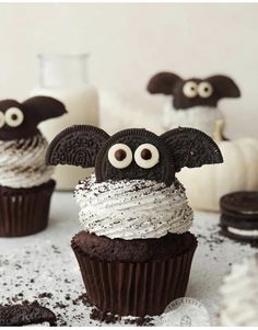 cupcakes decorated with chocolate frosting and googly eyes are sitting on a table