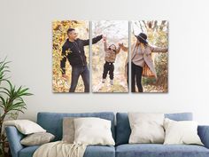 a couple of people that are standing in front of a blue couch and some pillows