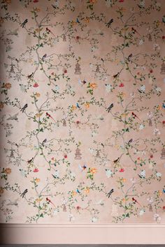 the wall paper has birds and flowers all over it, but no one is there