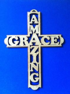 a wooden cross with the word grace carved into it's center on a blue background