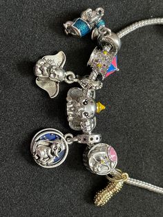 This is a handmade (hand put together) Disney's Dumbo Charm Bracelet! Disney Multicolor Jewelry Gift, Silver Disney Charm Bracelet As A Gift, Silver Disney Charm Bracelet Gift, Disney Silver Bracelet For A Gift, Disney Silver Bracelet Gift, Silver Disney Bracelet For Gift, Silver Disney Bracelet As Gift, Disney Charm Bracelet, Pandora Charms Disney