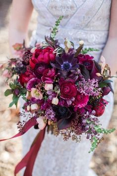 a bridal holding a purple and red bouquet