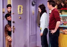 the cast of friends hanging out in front of a door with their faces on them