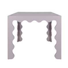 a small white table with scalloped legs