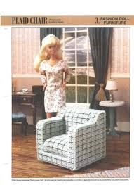 a doll standing next to a chair in a living room