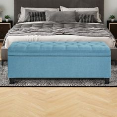 a bedroom with a large bed and blue ottoman