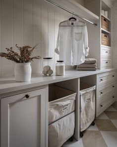 an organized closet with clothes and baskets