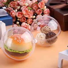 two plastic containers filled with food sitting on top of a table next to other items