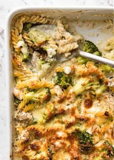 a casserole dish with broccoli and chicken in it, ready to be eaten