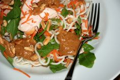 a white plate topped with noodles and meat