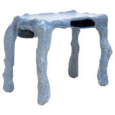 a small stool made out of foam with legs and feet sticking out from the top