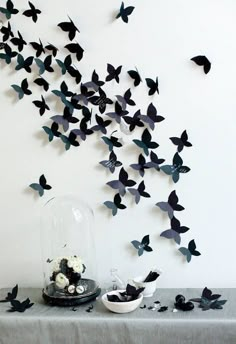 the butterflies are flying in the air above the table and on the wall next to the cake