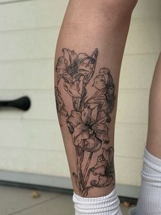 a woman's leg with flowers on it