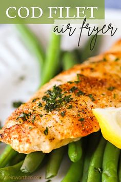 a plate with fish, asparagus and lemon wedges on it that says god filet air fryer