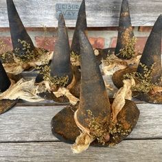 several black witches hats are sitting on a wooden bench with burlocks around them