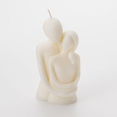 a candle that is shaped like a man and woman