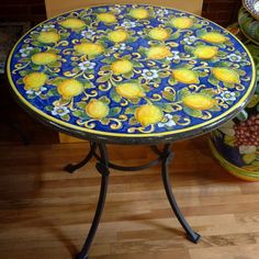 a blue table with yellow lemons painted on it