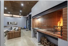 a living room filled with furniture and a fire place in the middle of an open floor plan