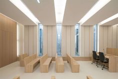 an empty room with wooden benches and desks