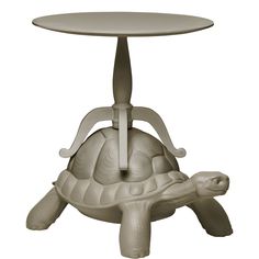 a small table with a turtle sitting on it's back and the base is made out of plastic