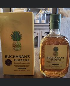 a bottle of buchan's pineapple on a table next to a box